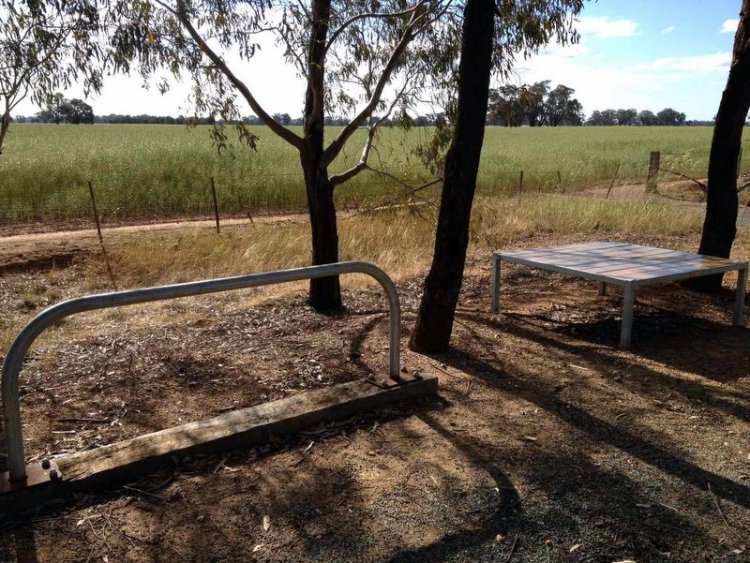 The seat and bike rack at the end of the trail -- time for a stretch of the legs, or lay out a small picnic by the paddock. 