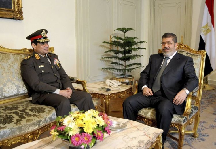 Egyptian Minister of Defense, Lt. Gen. Abdel-Fattah el-Sissi, left, meets with Egyptian President Mohammed Morsi at the presidential headquarters in Cairo, Egypt, February 2013 (photo credit: AP/Mohammed Abd El Moaty, Egyptian Presidency, File)