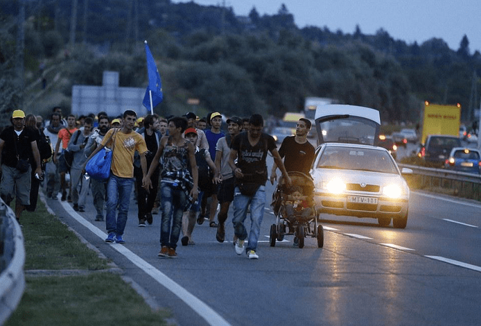 Refugees walk from Budapest to Austrian border, Friday 4 September 2015 (Photo: AP) 