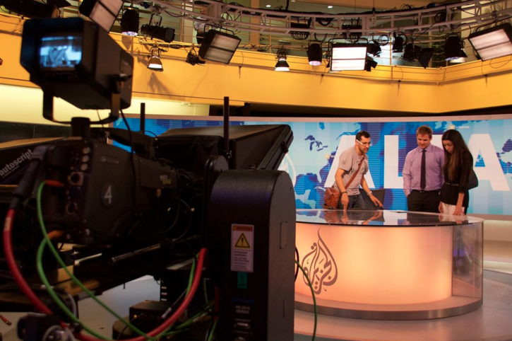 Al Jazeera presenter Kamahl Santamaria takes Zac Schroedl (middle) and Scherry Bloul (right) on a tour of the Al Jazeera studios in the organisation's headquarters in Doha, Qatar. 